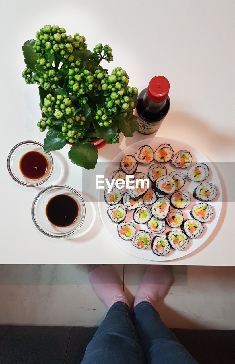 HIGH ANGLE VIEW OF WOMAN WITH VEGETABLES ON TABLE