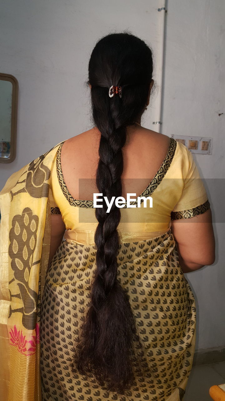 Rear view of woman with long braided hair