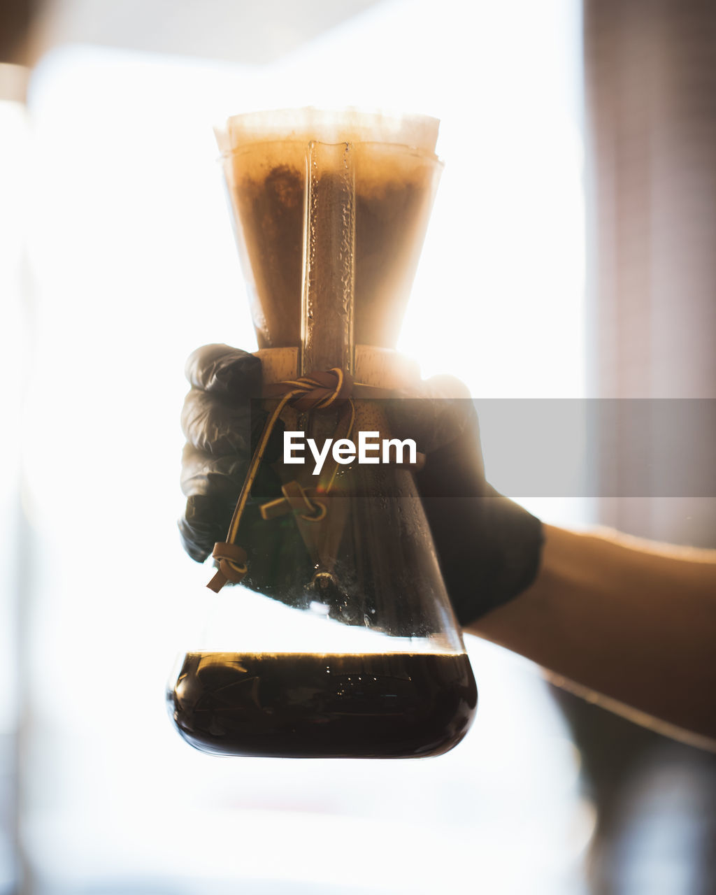 CLOSE-UP OF COFFEE CUP ON GLASS TABLE