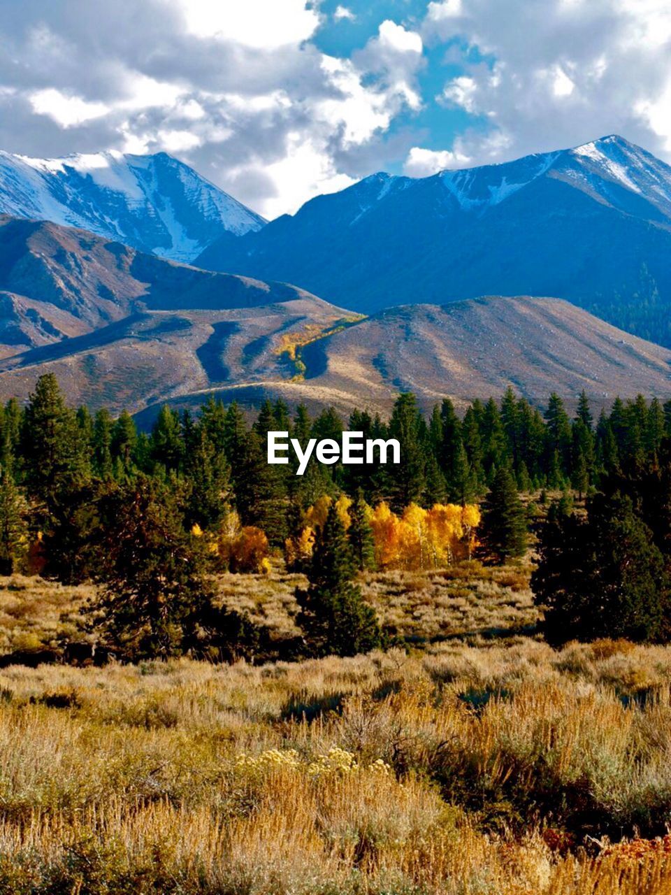 SCENIC VIEW OF MOUNTAINS AGAINST CLOUDY SKY