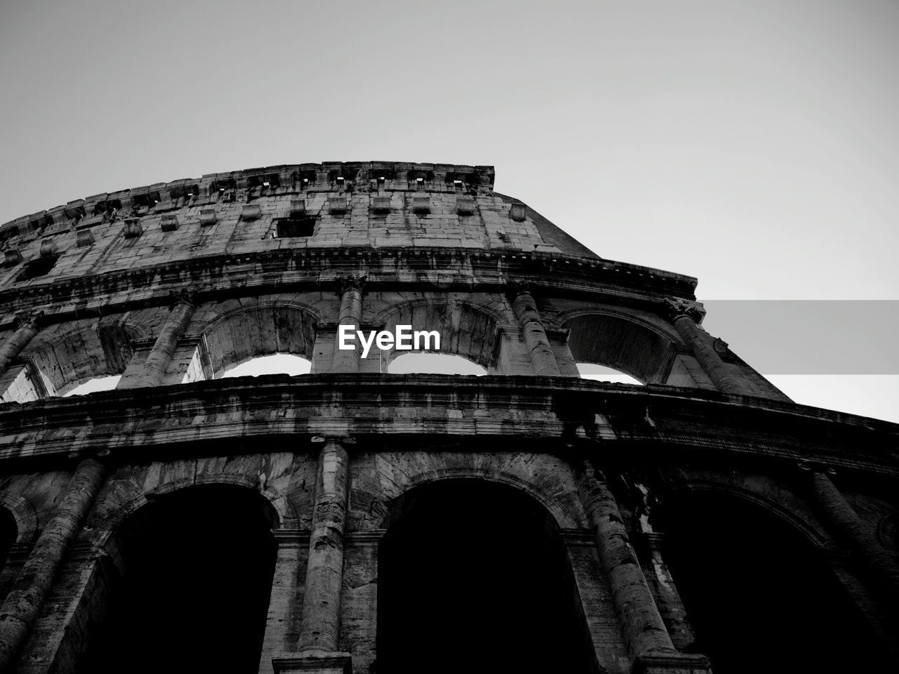 Low angle view of coliseum against clear sky