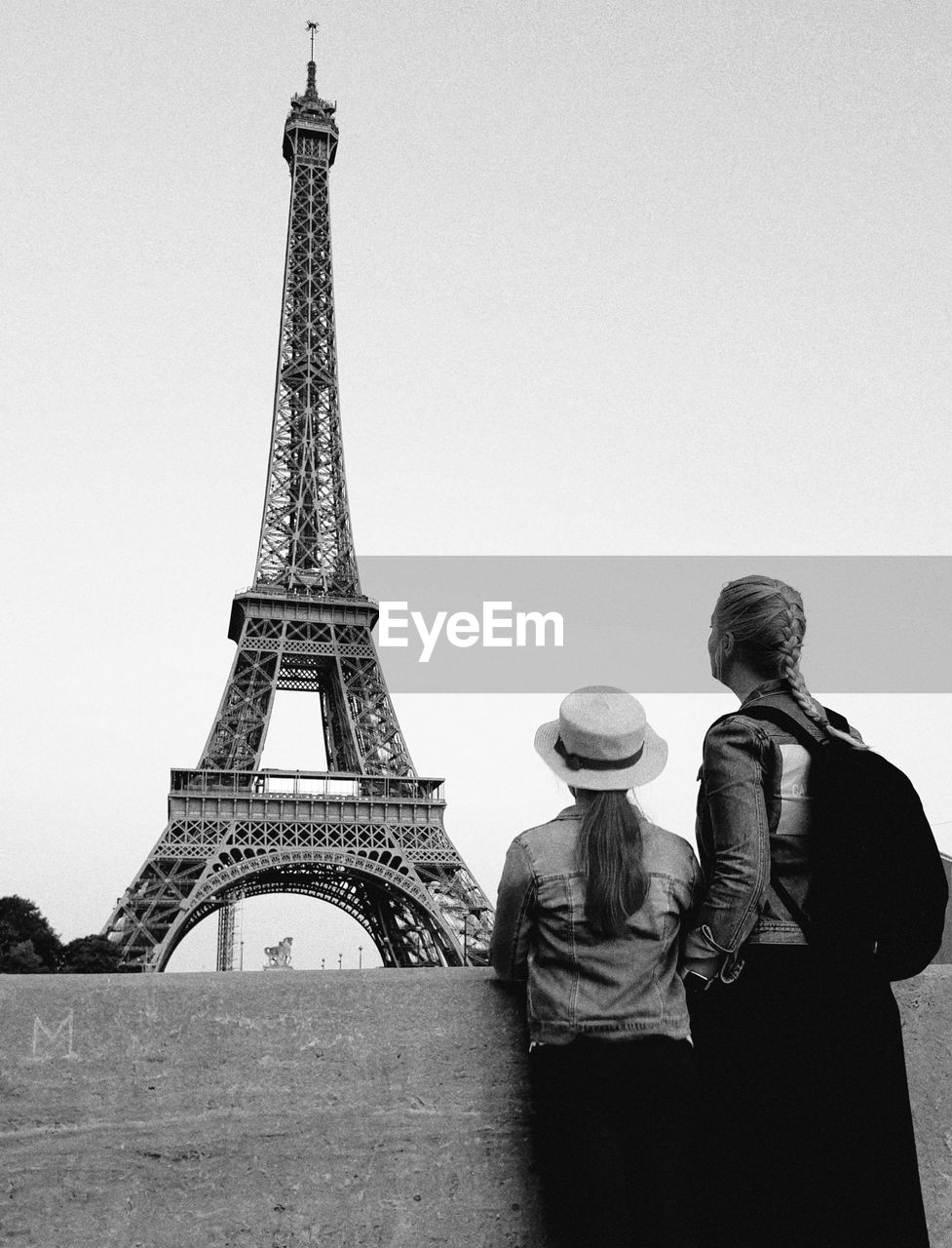 Rear view of woman with daughter looking at eiffel tower