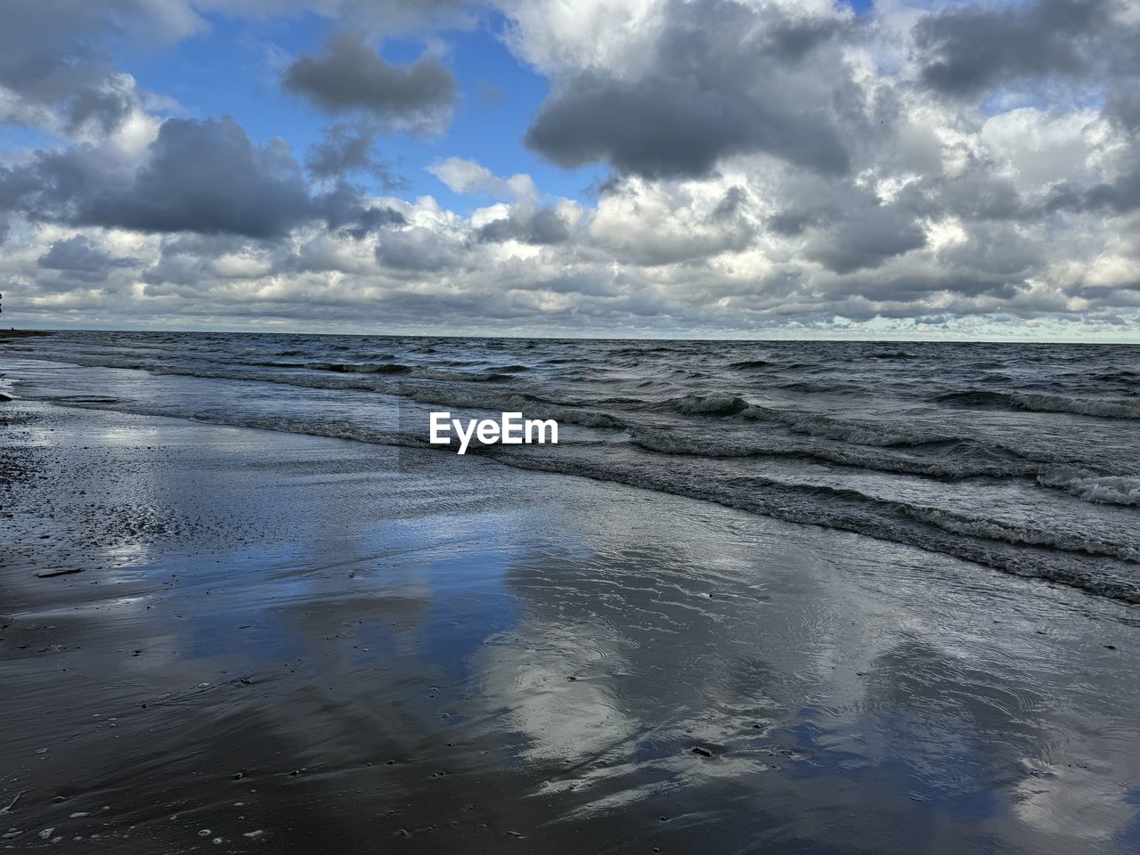 water, sky, cloud, sea, horizon, ocean, wave, shore, reflection, wind wave, beauty in nature, scenics - nature, land, nature, coast, beach, body of water, environment, tranquility, sunlight, landscape, tranquil scene, horizon over water, no people, outdoors, ice, blue, sand, day, travel, travel destinations, dramatic sky, morning, wet, idyllic, seascape, dusk, non-urban scene, motion, winter