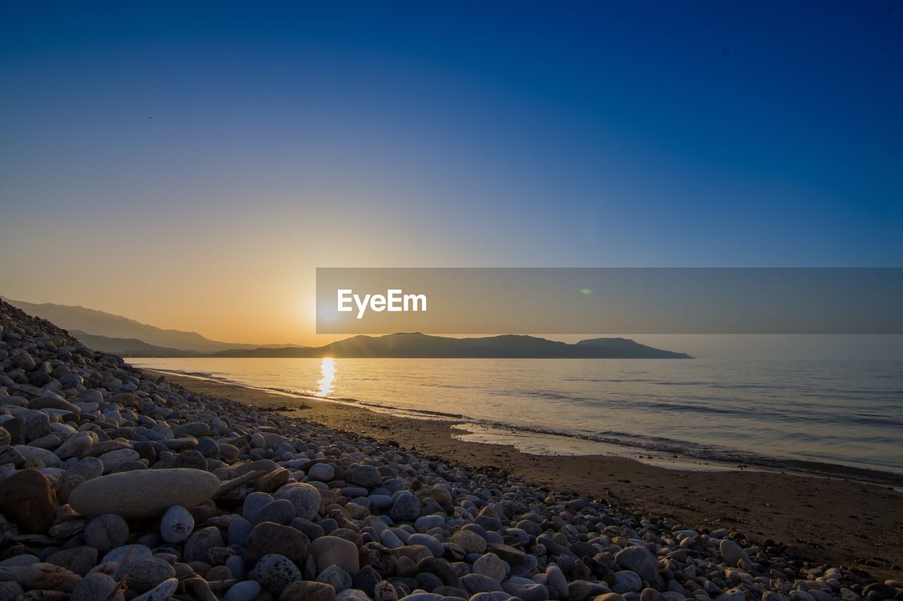 Scenic view of sea against clear sky during sunset