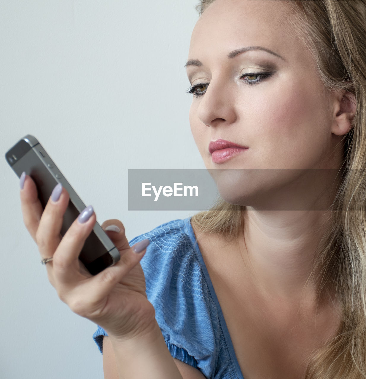 Close-up of beautiful woman using smart phone at home