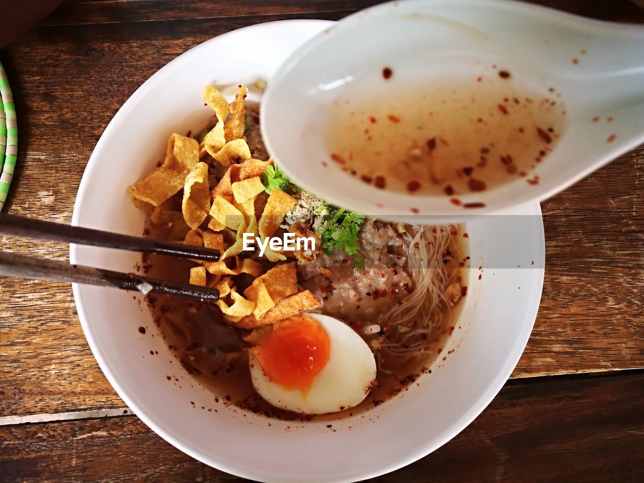 High angle view of spoon against soup in bowl