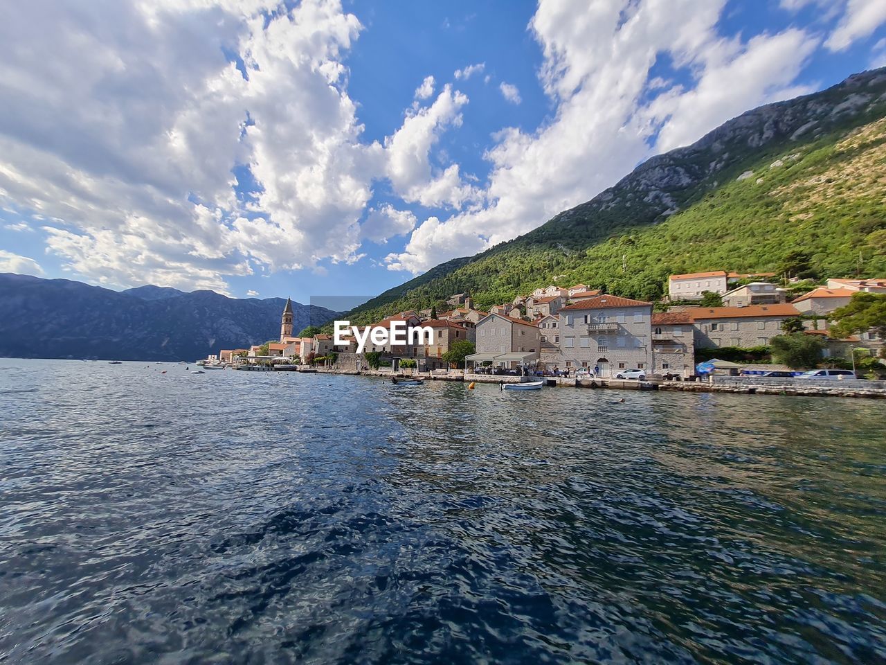 Scenic view of sea and mountains against sky