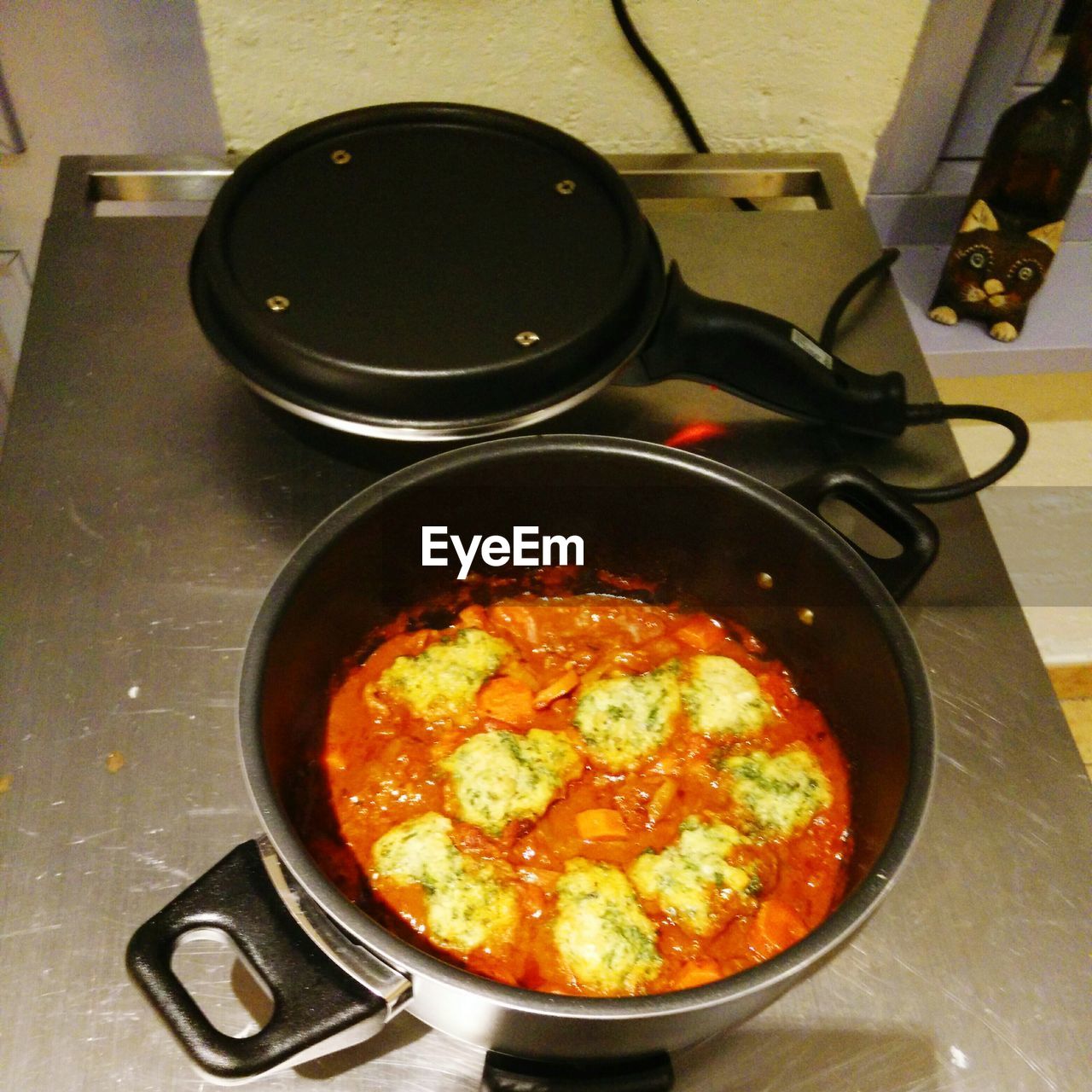 COOKING PAN ON STOVE IN KITCHEN