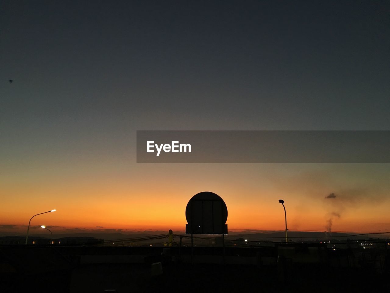 Silhouette built structure against sky during sunset