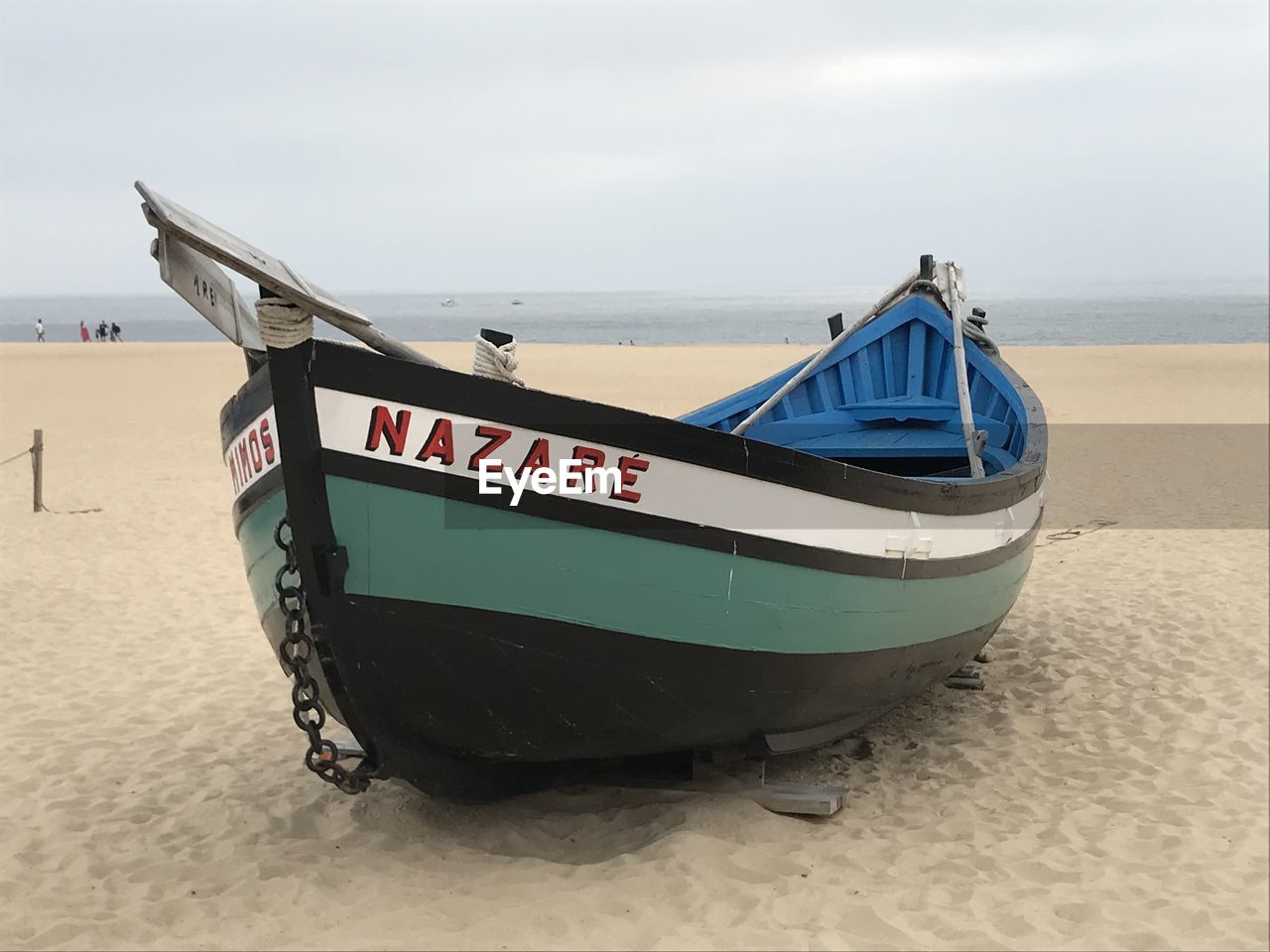 beach, sand, land, water, nautical vessel, transportation, sea, mode of transportation, boat, vehicle, nature, sky, travel, watercraft, skiff, no people, long-tail boat, text, moored, tranquility, outdoors, scenics - nature, dinghy, day, travel destinations, tranquil scene, environment, holiday, western script, speedboat, beauty in nature, coastline, vacation