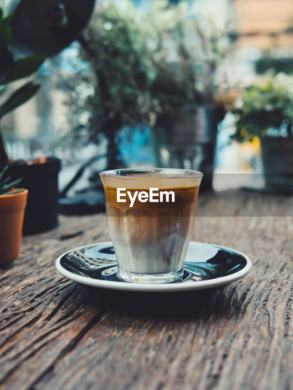 CLOSE-UP OF COFFEE SERVED ON TABLE AT CAFE