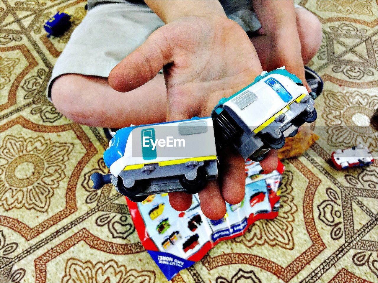 High angle view of toy train on palm