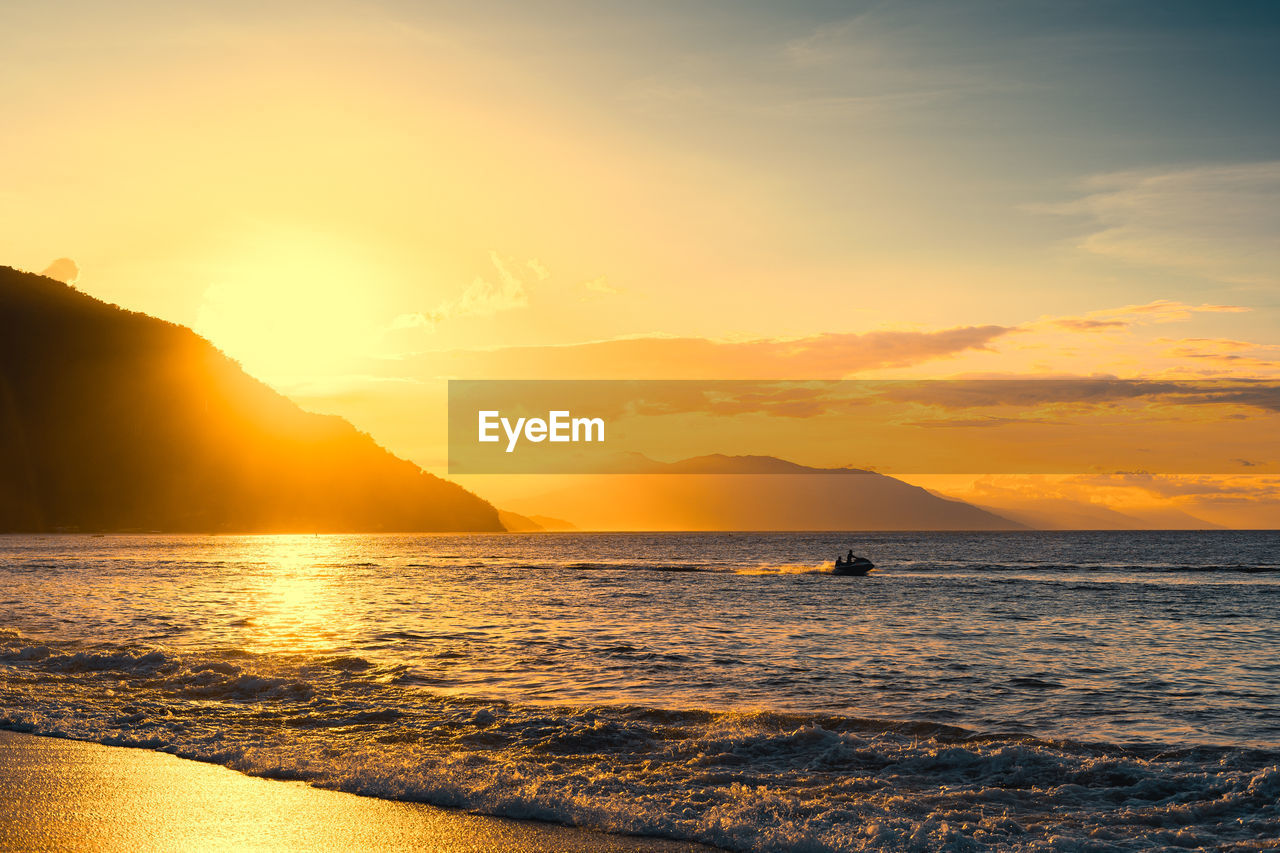 Enjoying summer at the beach of puerto galera, philippines at sunset.