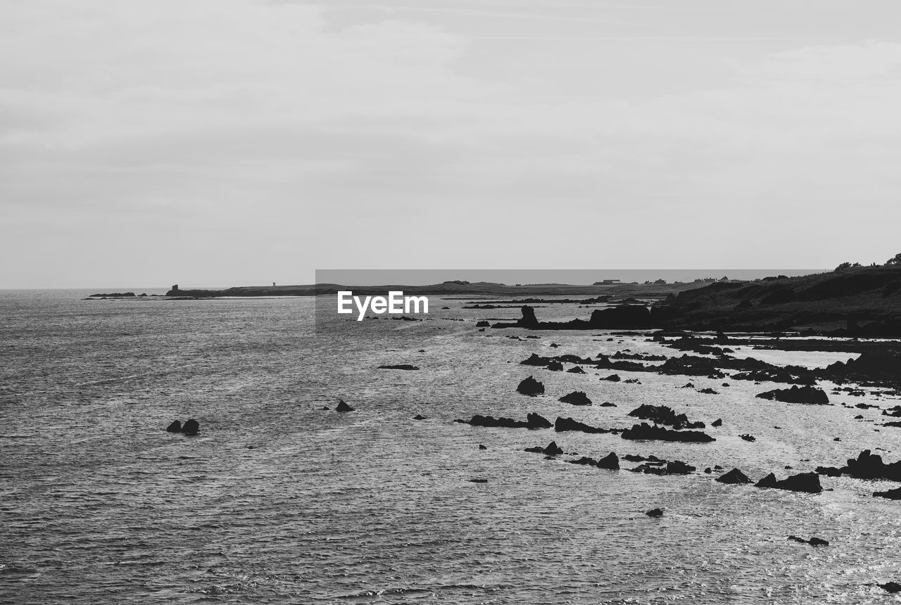 SCENIC VIEW OF SHORE AGAINST SKY