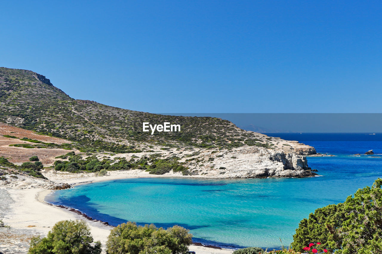 SCENIC VIEW OF SEA AND MOUNTAINS AGAINST CLEAR BLUE SKY