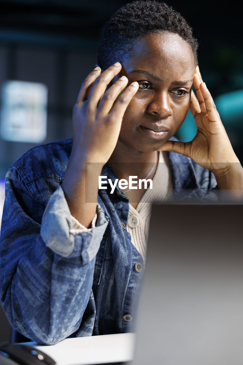 portrait of young woman using laptop