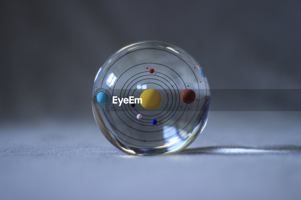 Close-up of glass ball on table