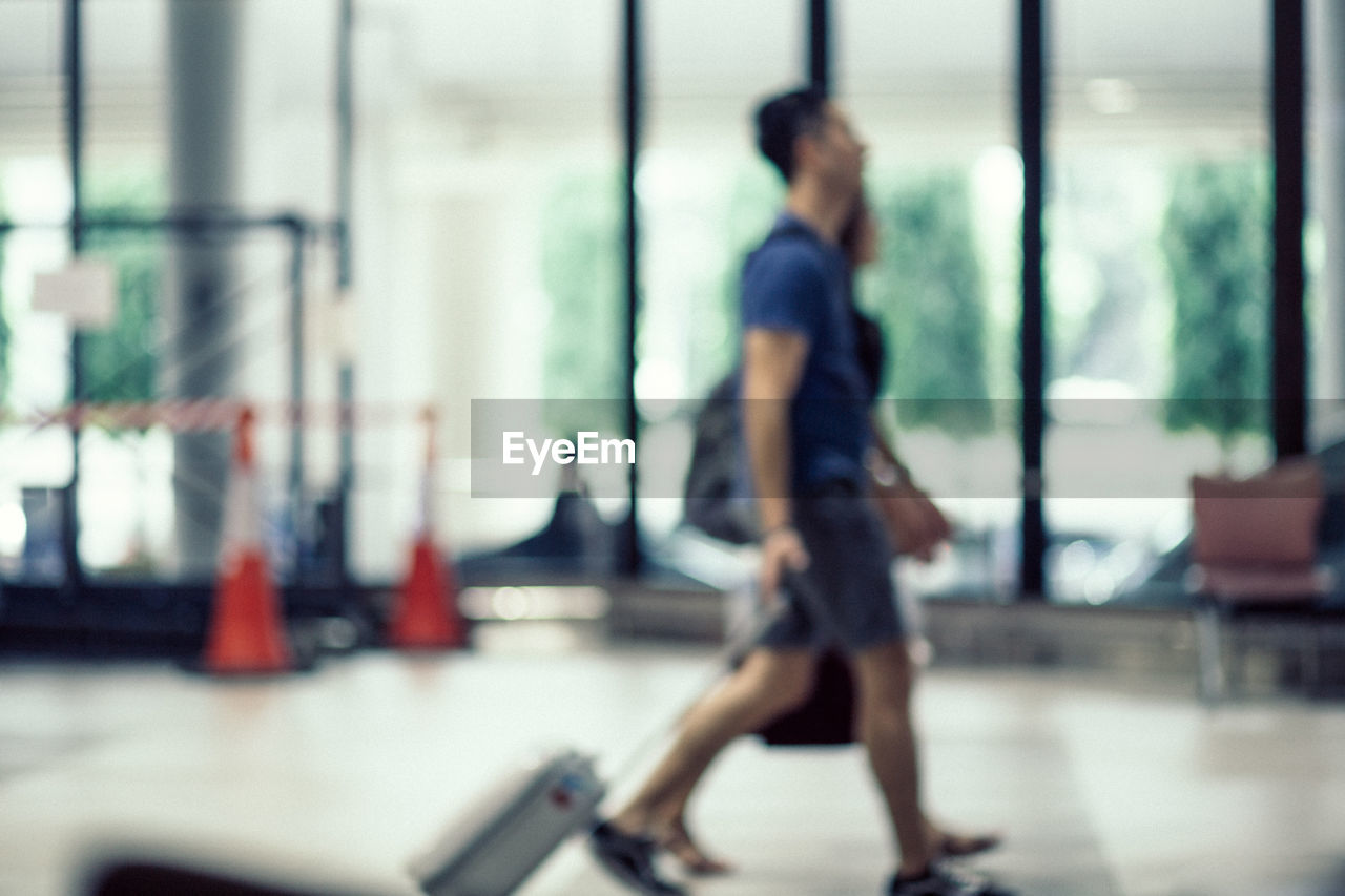 BLURRED MOTION OF MAN WALKING IN BUILDING