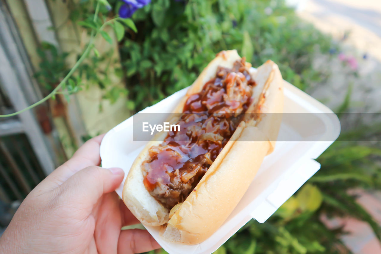 cropped hand of man holding food