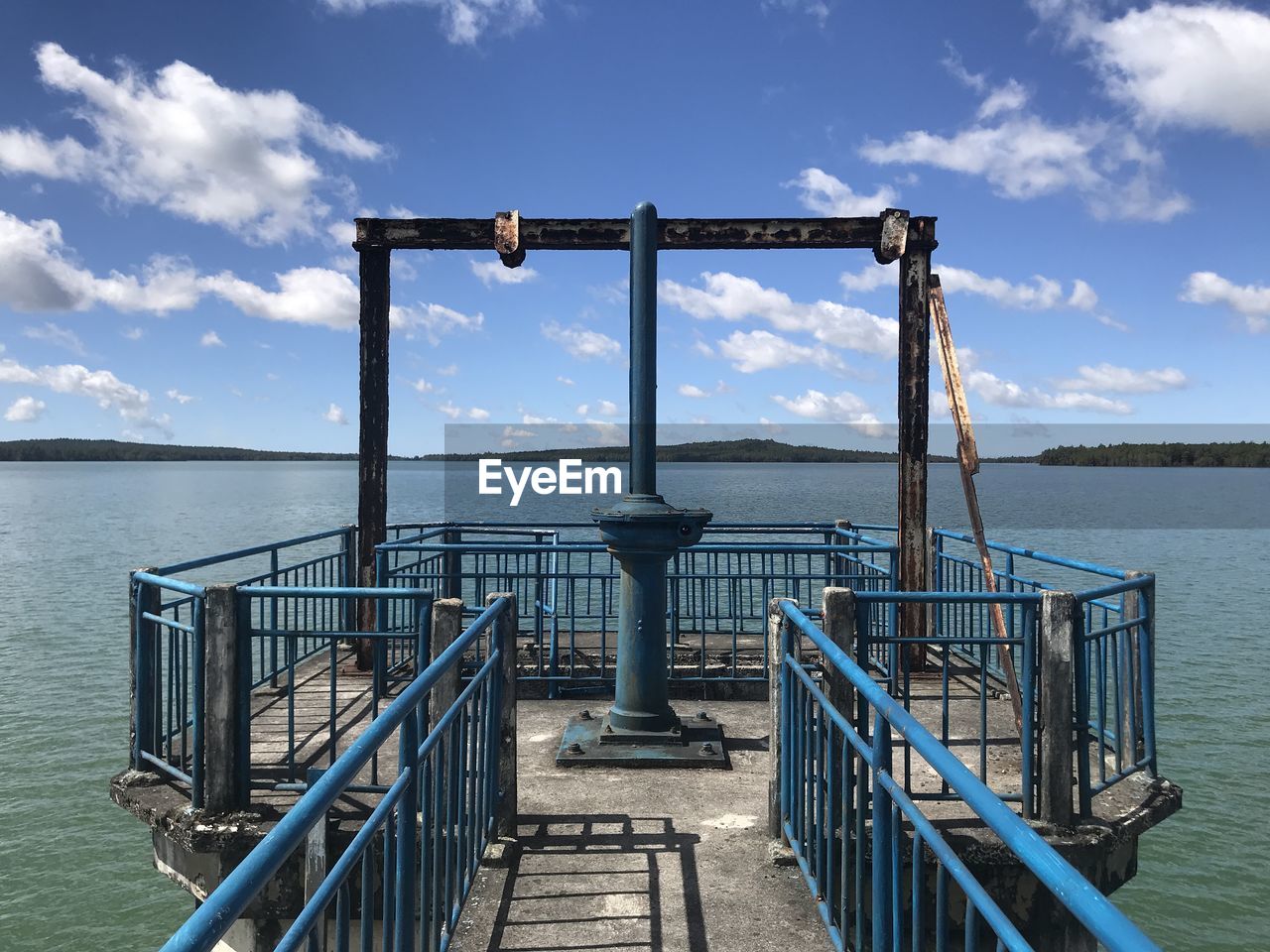 RAILING AGAINST SEA AGAINST SKY