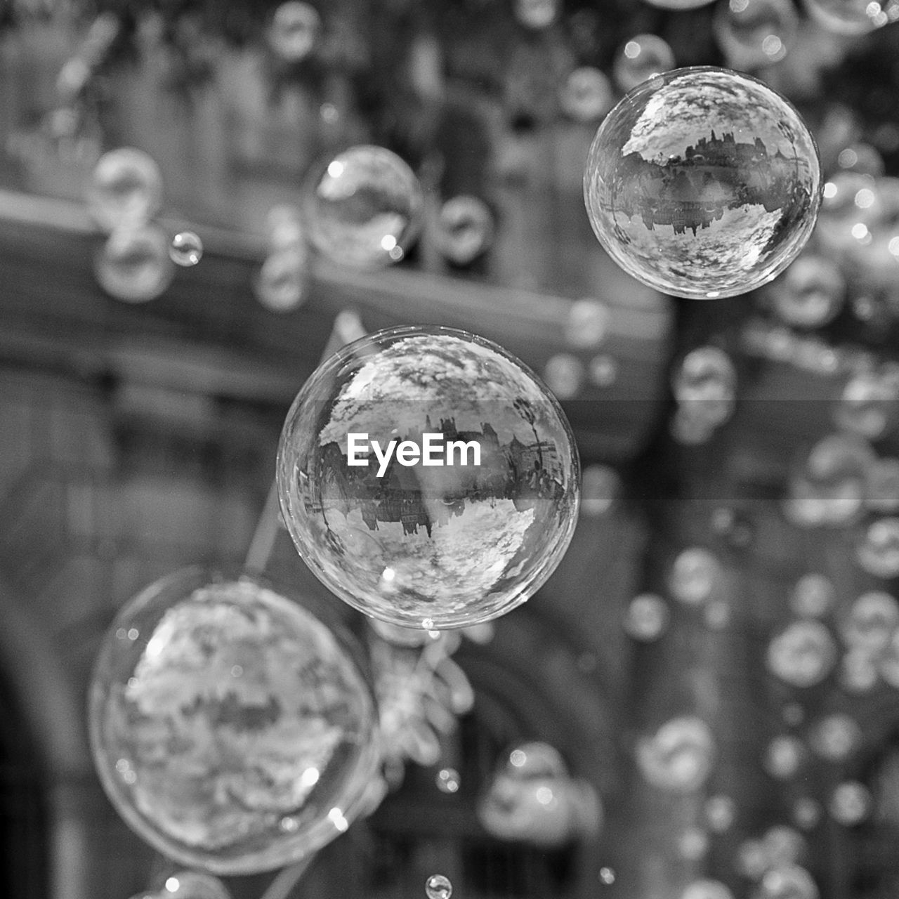 bubble, liquid bubble, close-up, soap sud, sphere, black and white, focus on foreground, fragility, macro photography, monochrome photography, reflection, mid-air, disco ball, shiny, monochrome, no people, white, water, hanging, selective focus, transparent, black, shape, nature, geometric shape, glass, bubble wand, decoration, light, drop, outdoors, circle, tree