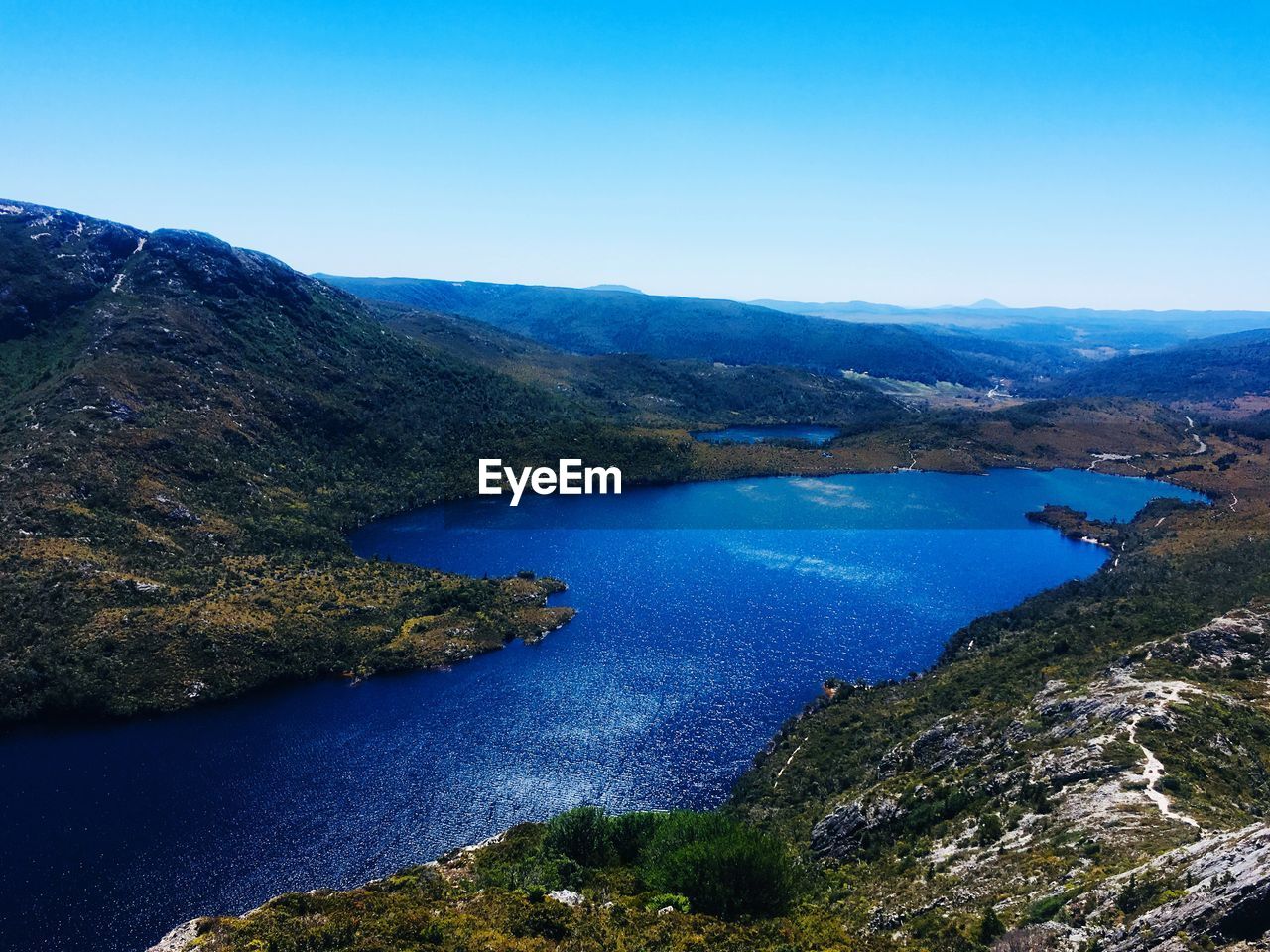 High angle view of lake against clear blue sky