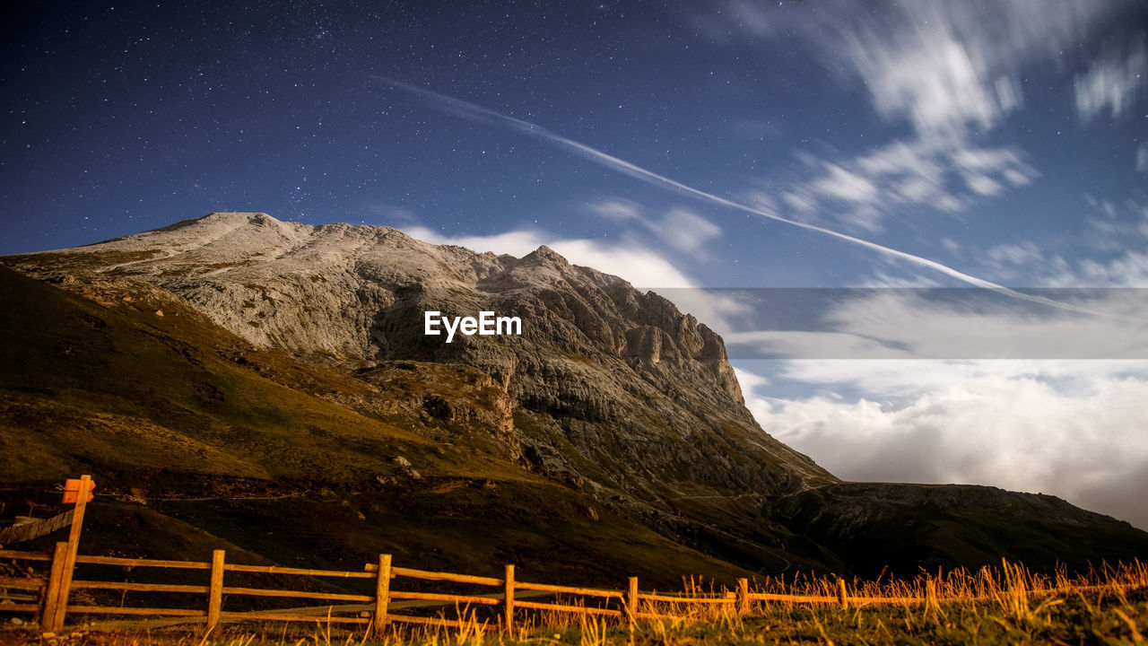 Scenic view of mountains against sky at night