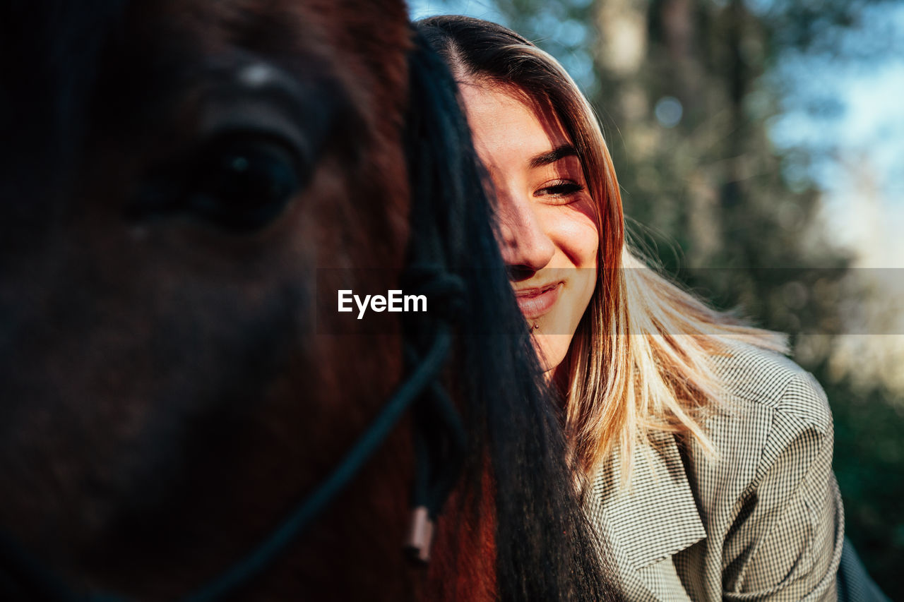 Smiling woman sitting on horse