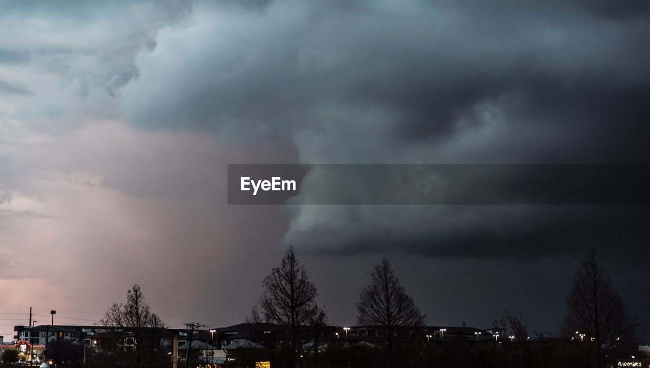 LOW ANGLE VIEW OF CITY AGAINST DRAMATIC SKY