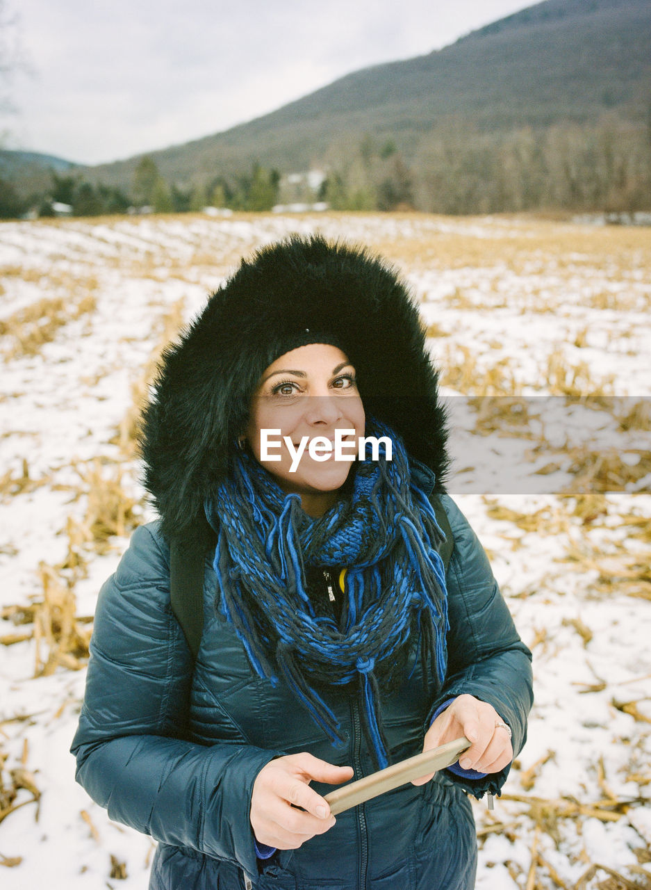 Smiling woman standing on field