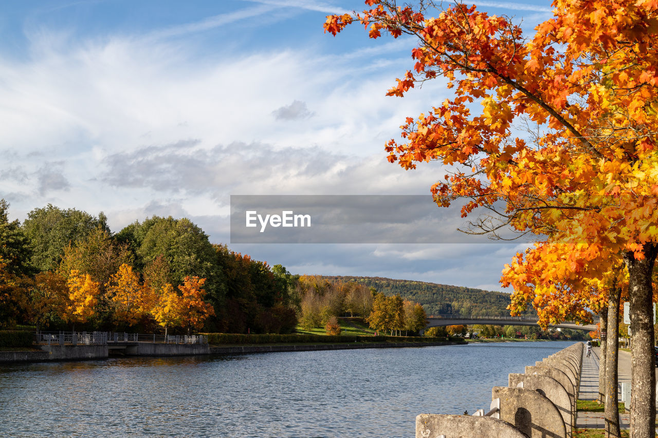 Autumn landscape with multicolored trees and the altmuehl river in berching, bavaria on a sunny day