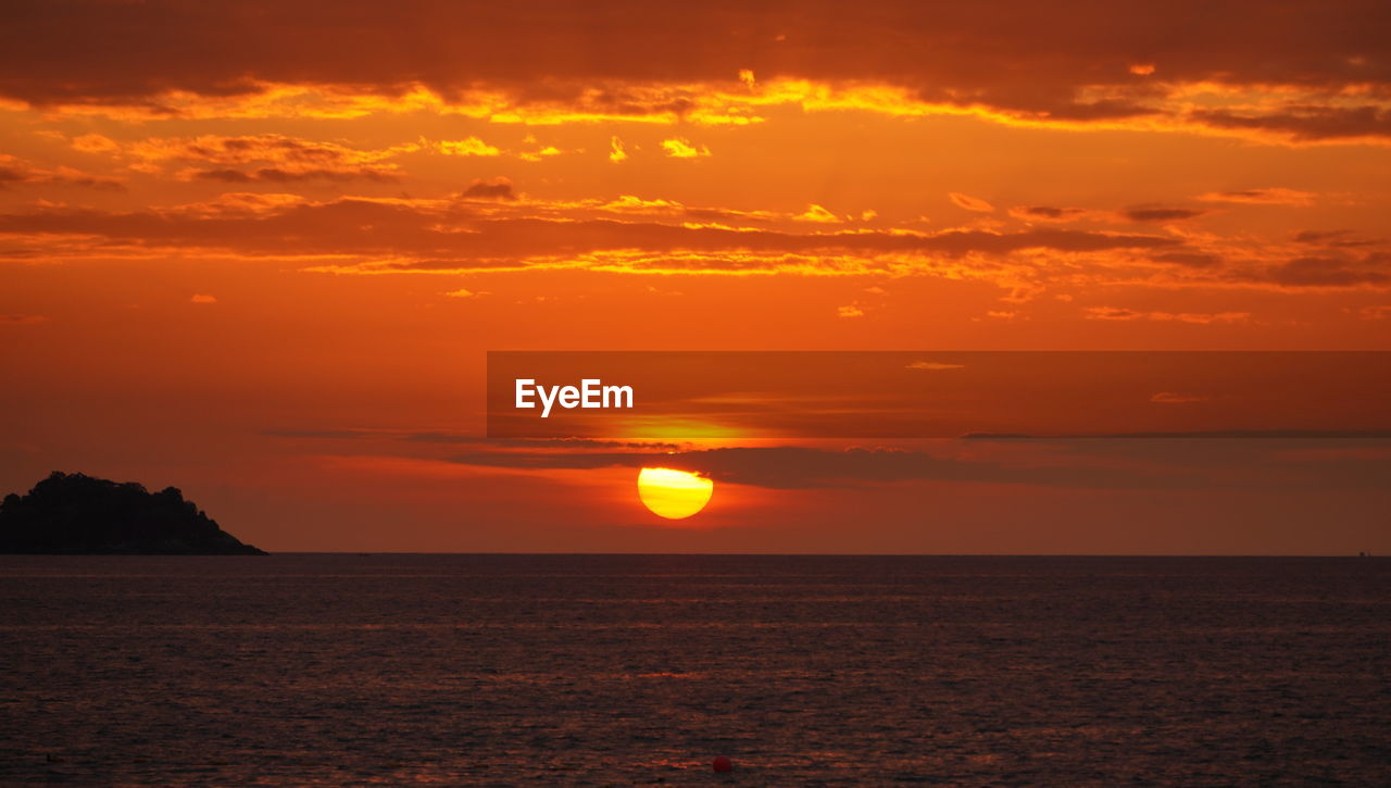 Scenic view of sea against romantic sky at sunset