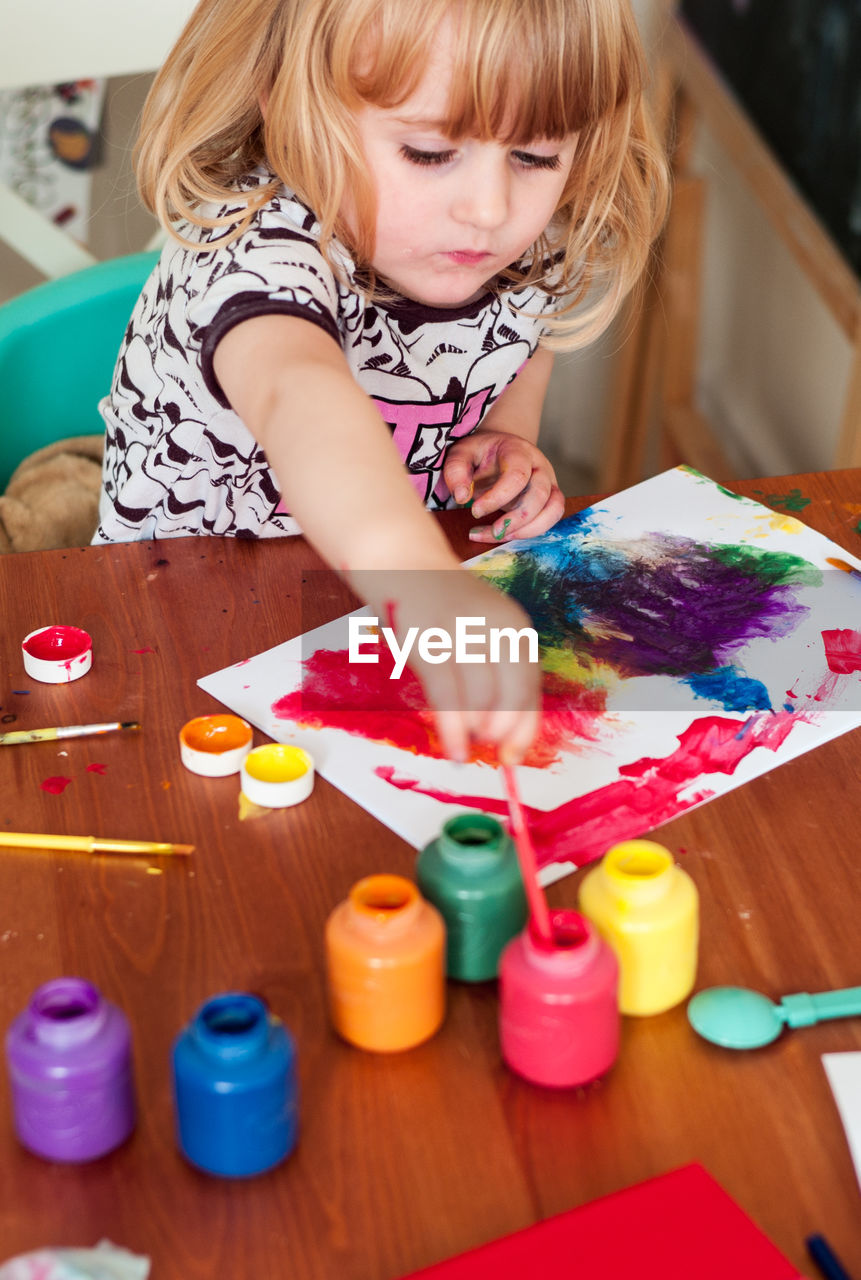 Girl painting with watercolors