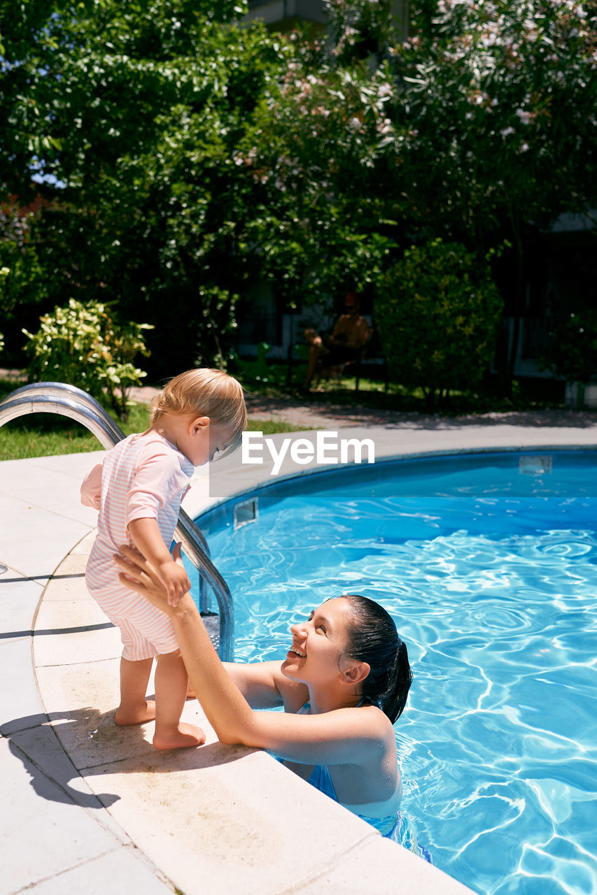 Father and daughter in swimming pool