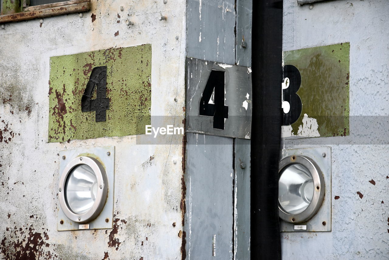 wall, door, entrance, no people, old, metal, iron, close-up, urban area, number, white, day, green, weathered, protection, art, security, architecture, wall - building feature, abandoned, closed, wood, outdoors, built structure