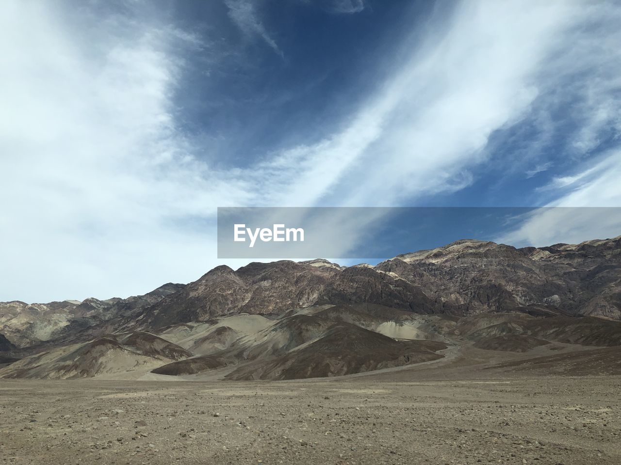 Scenic view of arid landscape against sky