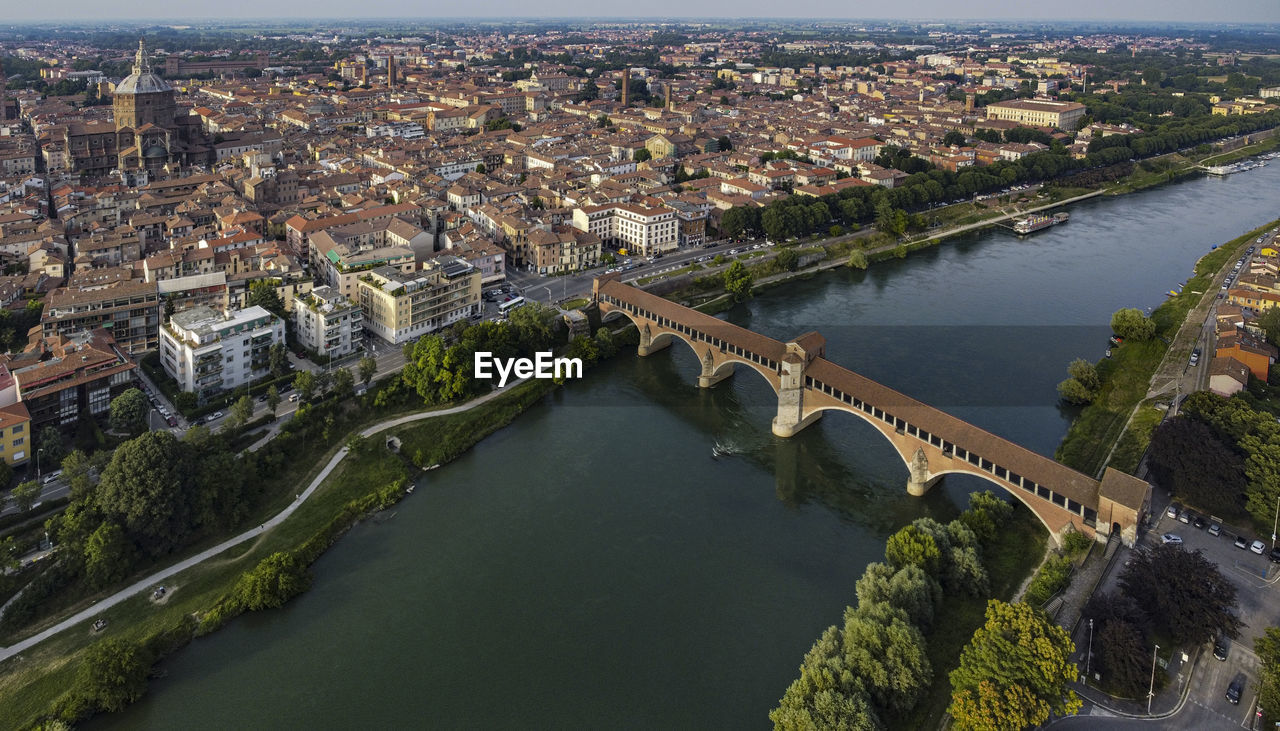 Classic aerial view of pavia, italy, in the afternoon. the dome and the old bridge on ticino river
