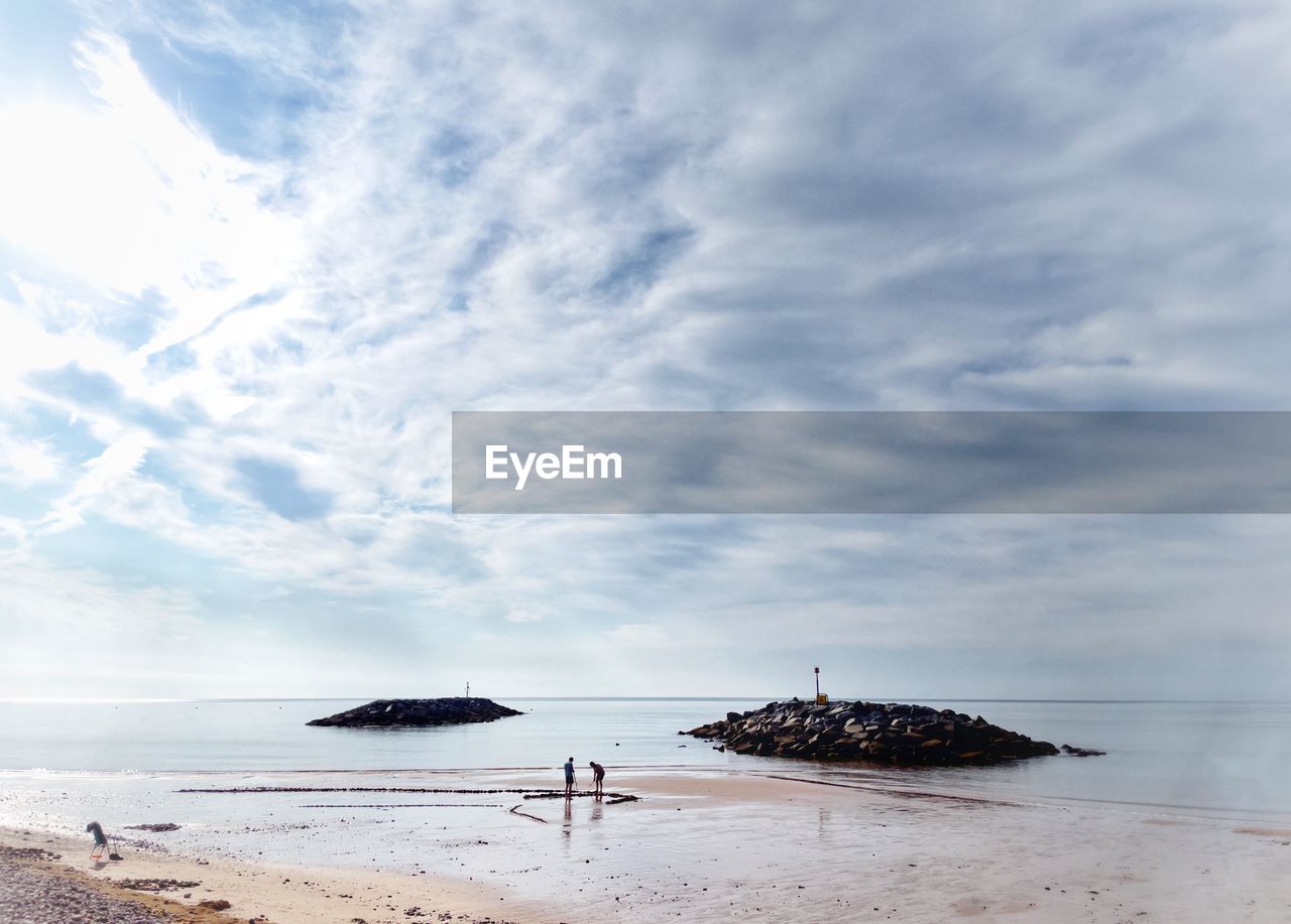 Scenic view of sea against sky two people 