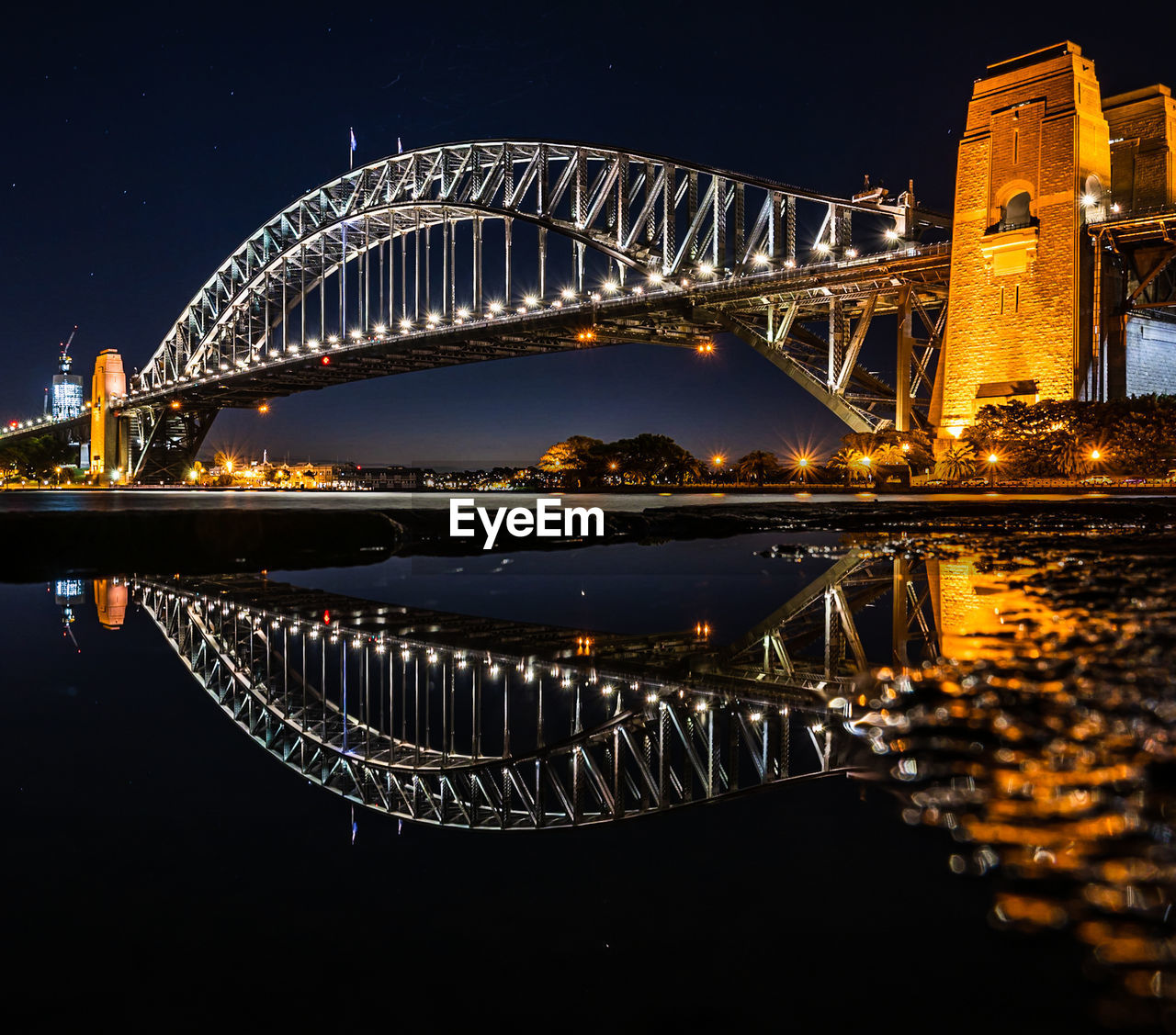 View of sydney harbour bridge at night.