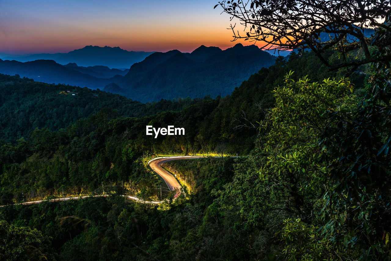 High angle view of road amidst green mountains