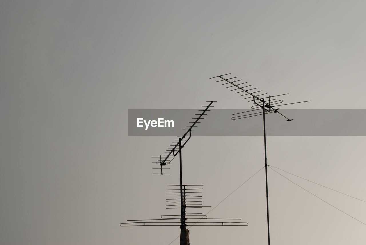 LOW ANGLE VIEW OF SILHOUETTE TELEPHONE POLE AGAINST SKY