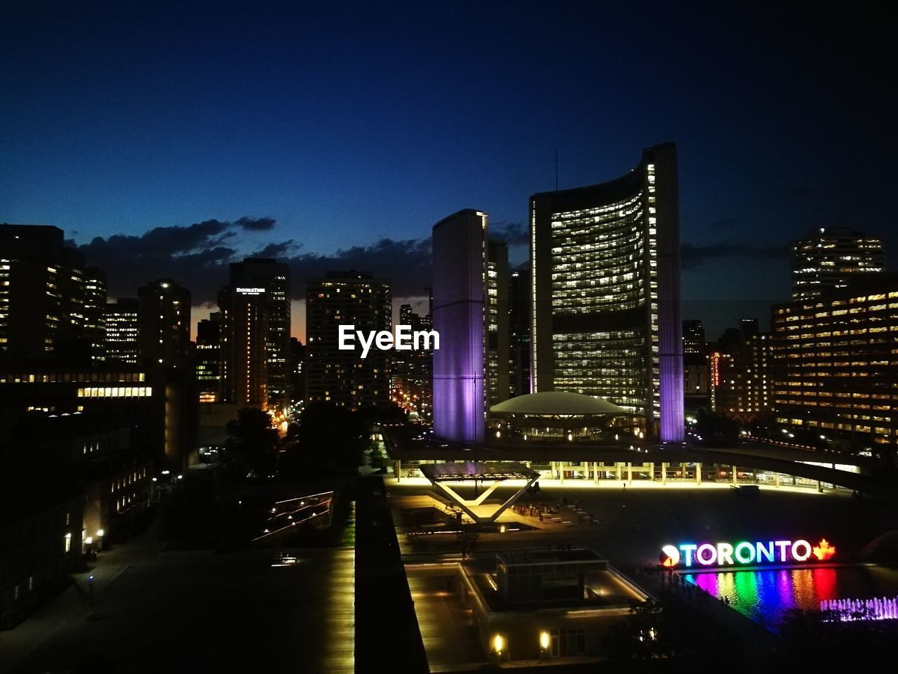 ILLUMINATED BUILDINGS AGAINST SKY AT NIGHT