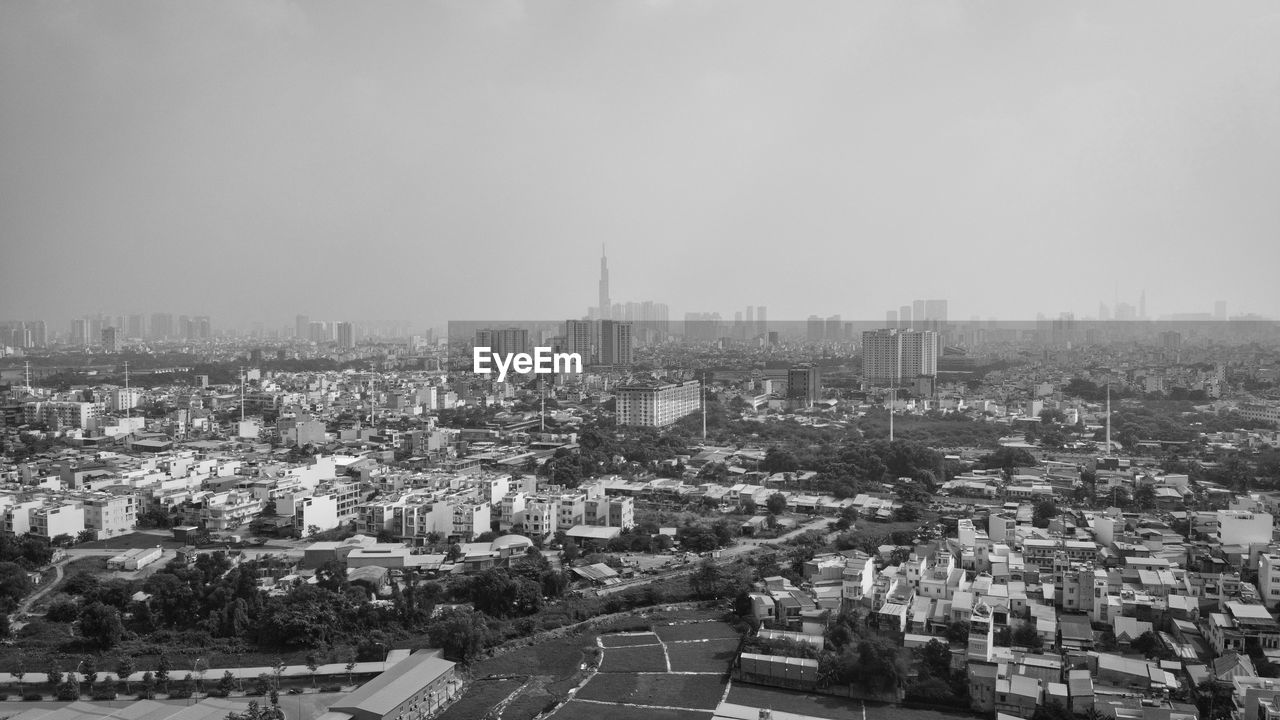 HIGH ANGLE VIEW OF CITYSCAPE AGAINST CLEAR SKY