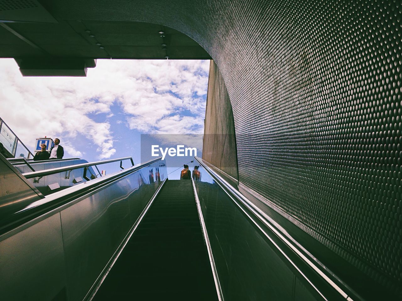 Low angle view of escalator against sky