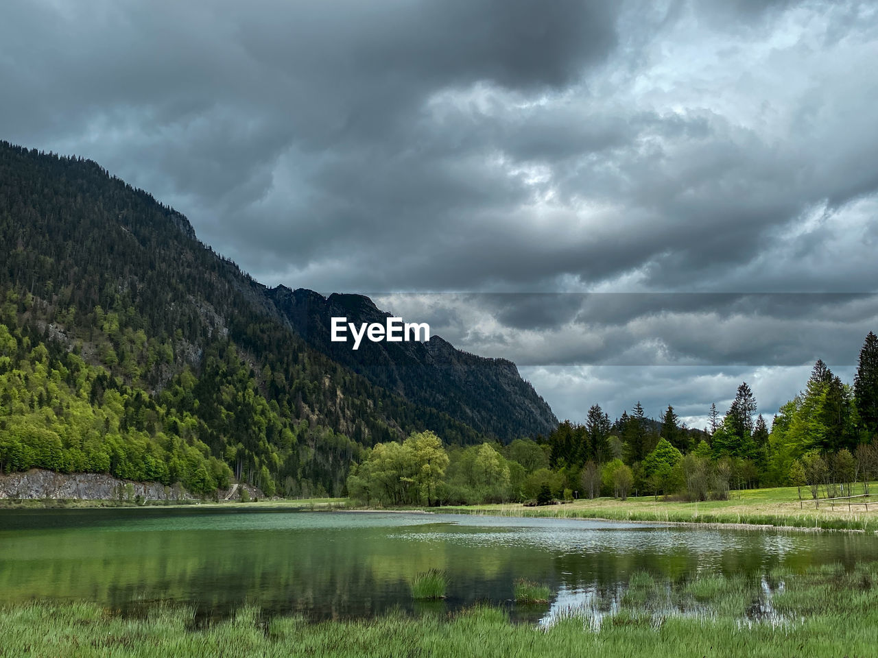 Scenic view of lake and mountains against cloudy sky at dreiseengebiet, bavaria