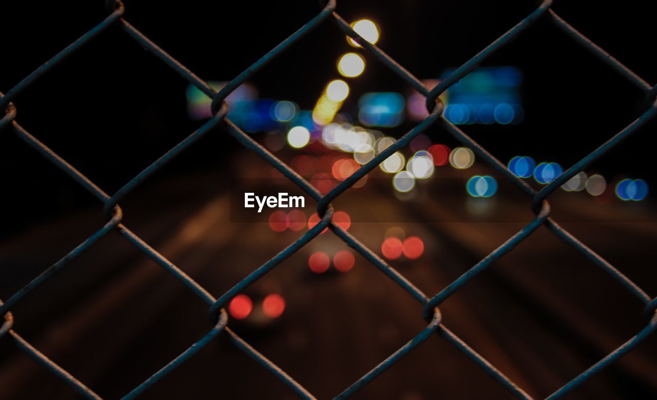 Full frame shot of chainlink fence at night