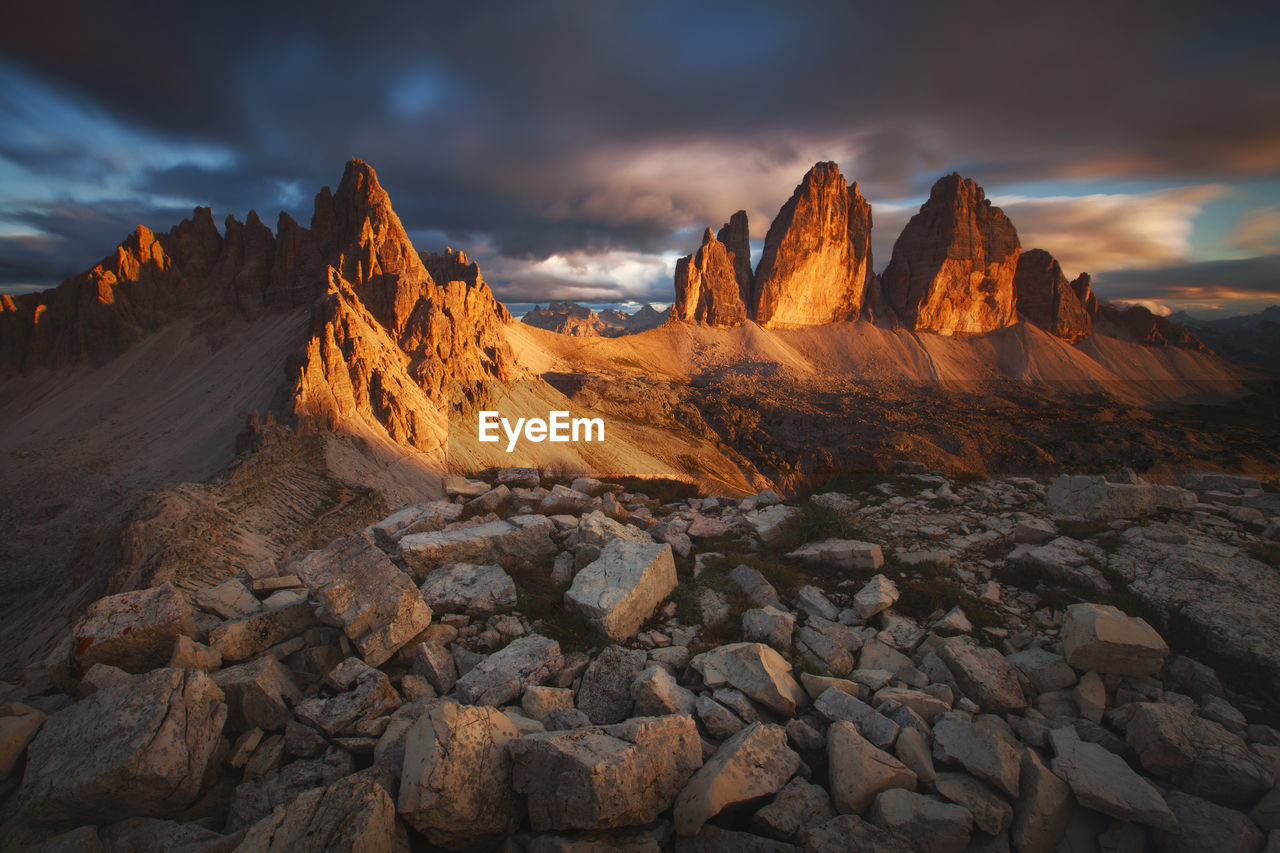 Rock formations on landscape against sky during sunset