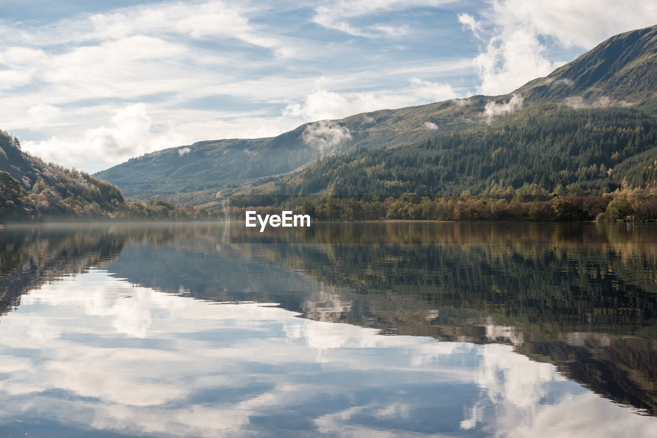 Scenic view of lake and mountains against sky