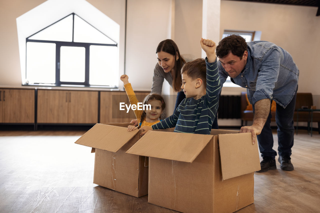 man playing with toy blocks on table at home