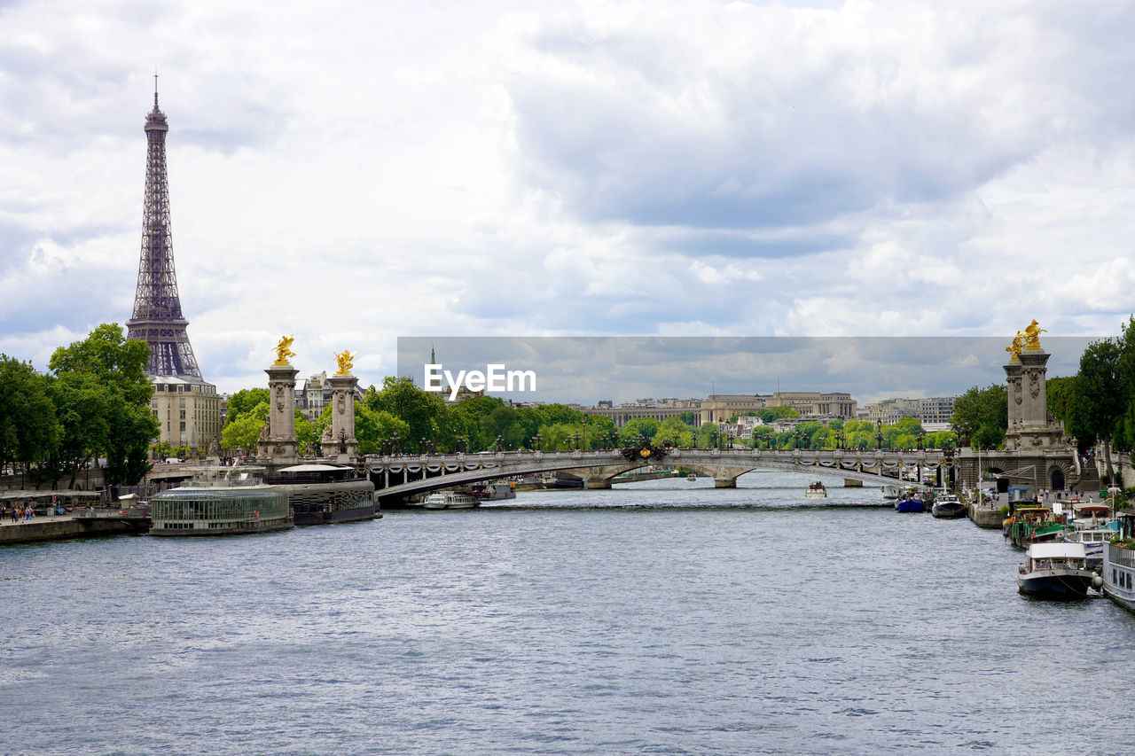 Seine river with pont alexandre iii bridge and eiffel tower in paris, france